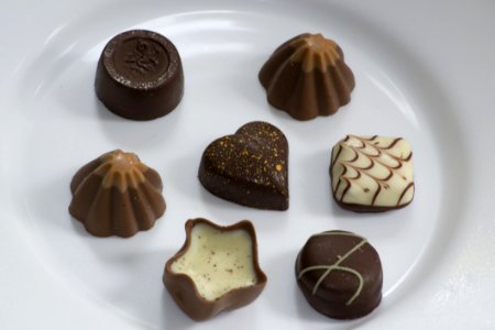 Picture Of Assorted Swiss Chocolate Bonbons Isolated On White Plate photo