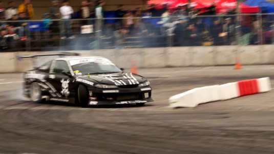 Black-nissan-sylvia-sliding-through-curve