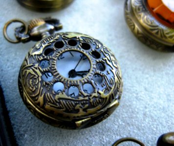 Antique-pocket-watch-with-ornamented-bronze-casing