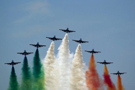 Frecce Tricolori Flying In V Formation And Leaving Italian Flag Colored Smoke Trails photo