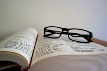 Close-up Of Eyeglasses On Book photo