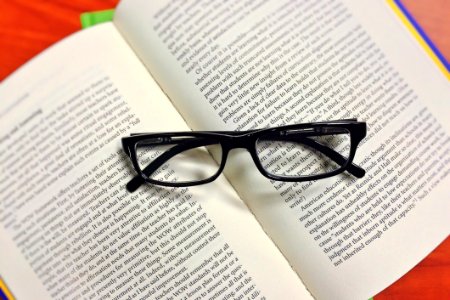 Black Framed Eyeglasses On Book photo