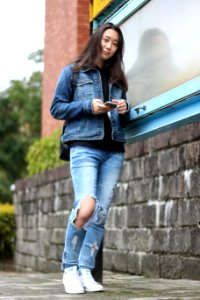 Full Length Of Woman Using Mobile Phone In City