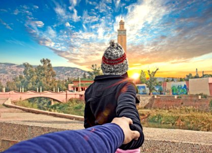 Rear View Of Man Photographing Cityscape Against Sky
