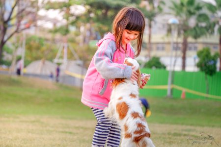 Portrait Of A Smiling Young Woman With Dog photo