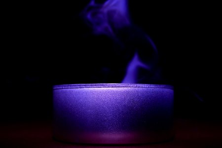 Close-up Of Blue Candle Against Black Background photo