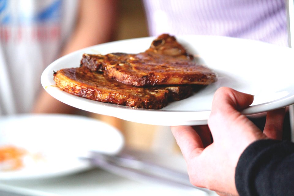 Close-up Of Man Preparing Food In Plate