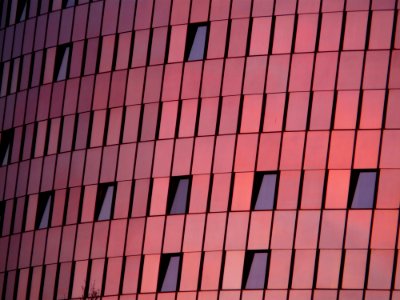 Black Mirror Mounted On Red Wall Building photo