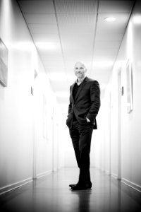 Full Length Portrait Of Man Standing In Corridor photo