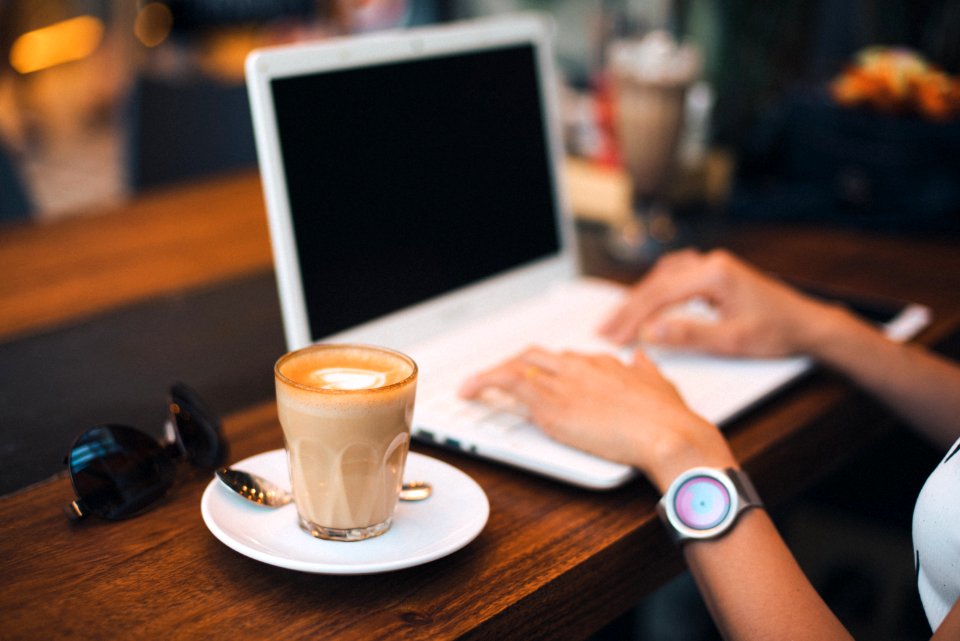 Midsection Of Man Using Mobile Phone While Sitting On Table photo