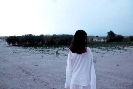 Rear View Of Woman Standing On Beach photo