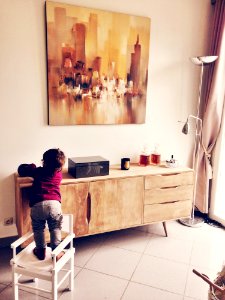 Child Climbing On Chair In Living Room