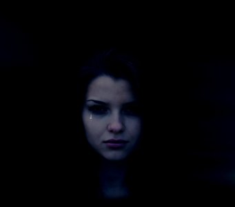 Crying Young Woman In Shadows photo