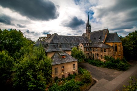3 Storey Mansion Near Trees Under Cloudy Sky