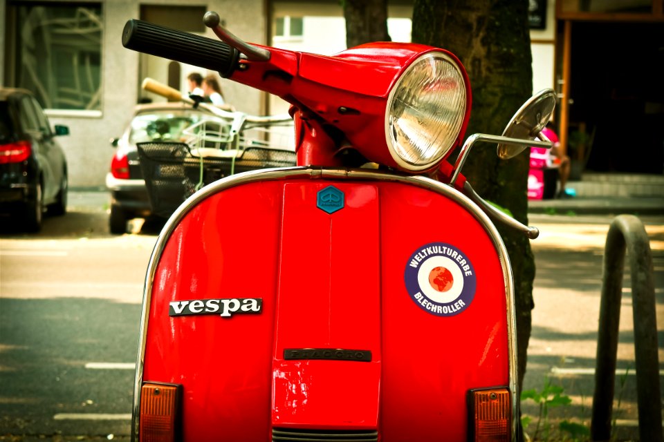 Red Vespa Motor Scooter Parked Near Tree During Daytime