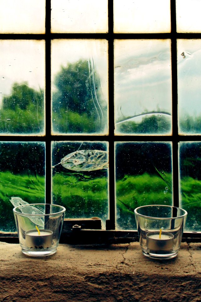 2 Tealight Candles On Window Pane