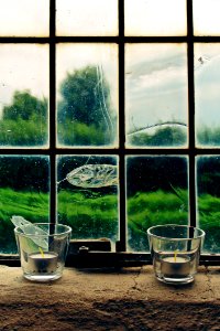 2 Tealight Candles On Window Pane
