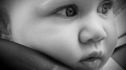 Close Up Photography Of Babys Face photo