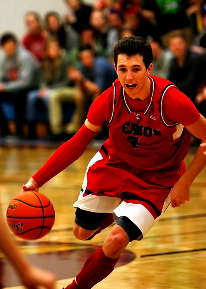 Basketball Player Wearing Red And Black Jersey
