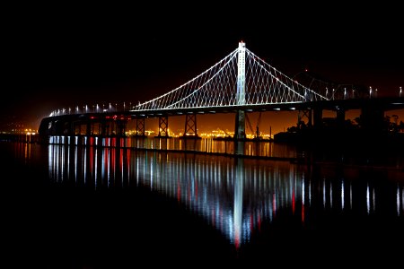 Illuminated Suspension Bridge Against Sky At Night photo