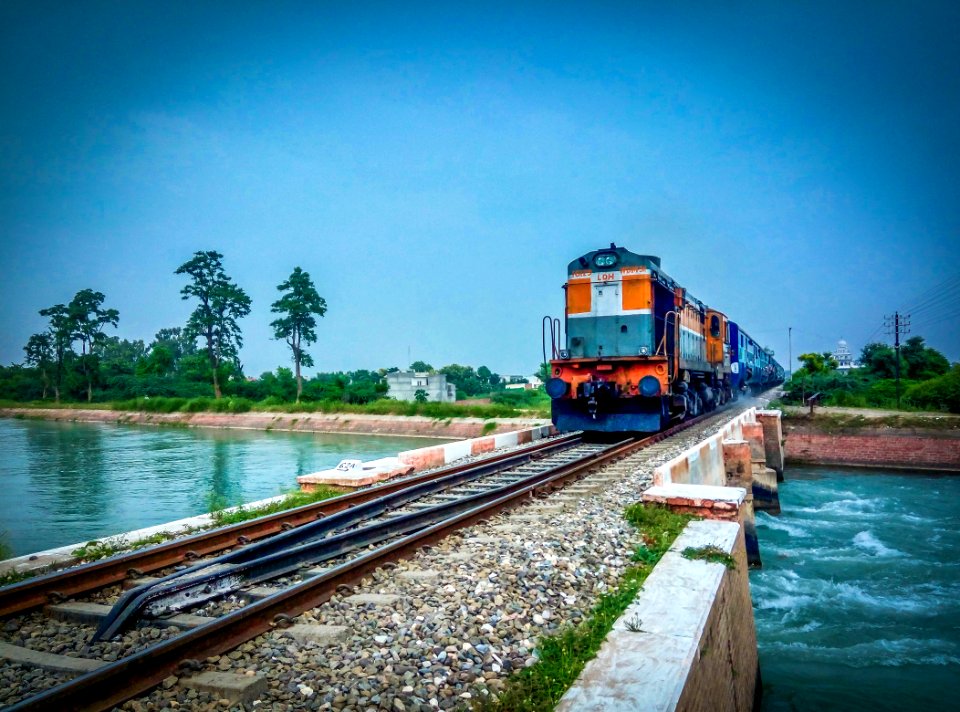 Train By Trees Against Blue Sky