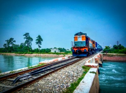 Train By Trees Against Blue Sky