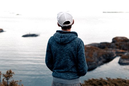 Rear View Of A Man Standing On Beach