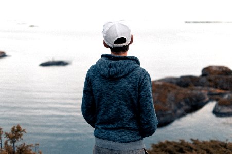 Rear View Of A Man Standing On Beach photo