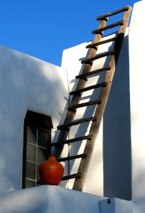 White Adobe House With Ladder