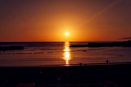 Scenic View Of Sea Against Sky During Sunset photo