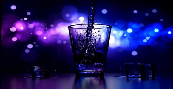 Close-up Of Water Splashing In Drinking Glass photo