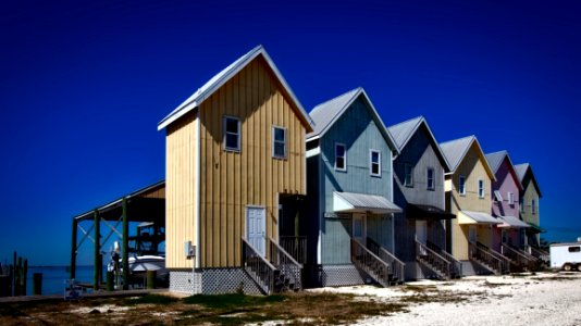 Inline House Near Seashore During Daytime photo