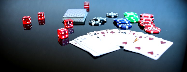 Playing Cards Beside Poker Chips And Dice
