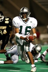 Man In White 16 Football Jersey While Playing Football