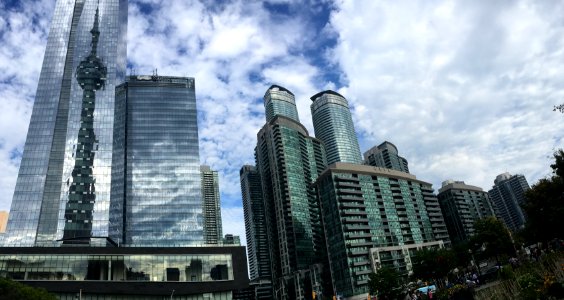Low Angle View Of Skyscrapers Against Cloudy Sky photo