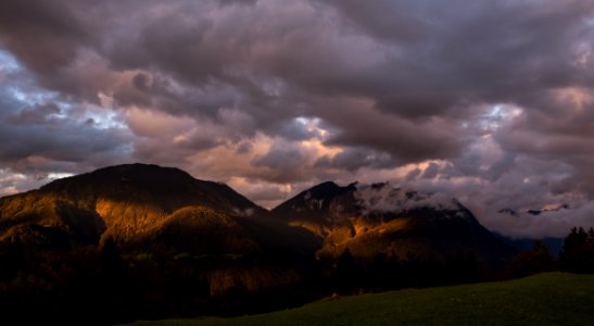 Dawn Through Clouds Over Mountain Peaks