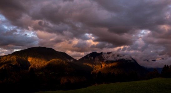 Dawn Through Clouds Over Mountain Peaks photo