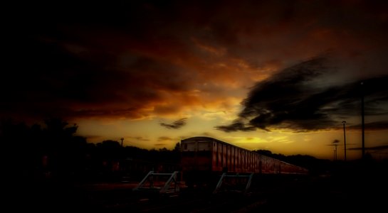 Red And White Train Taken During Sunset photo