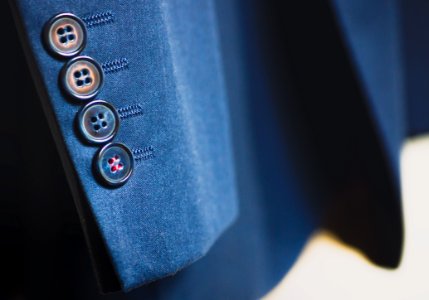 Shallow Focus Photography Of Black Button On Formal Suit Jacket Sleeves