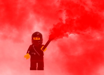 Lego Mini Figure Character In Red Smoke photo