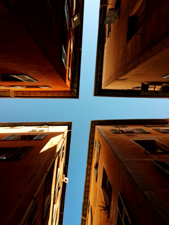 Worms Eye View Of 4 Brown Concrete Buildings At Daytime