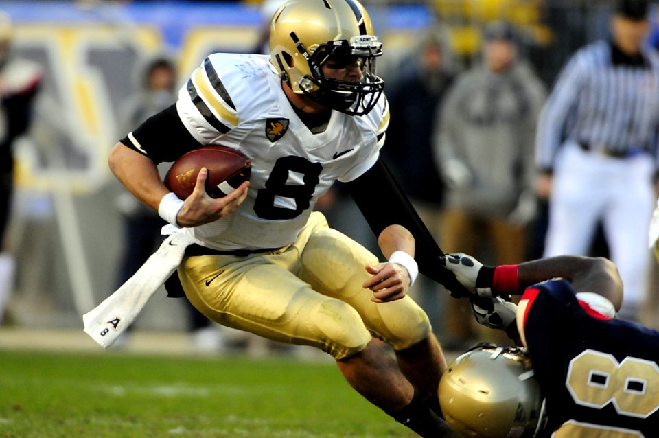 Man In Black Jersey Holding Jersey Number 8 With Ball