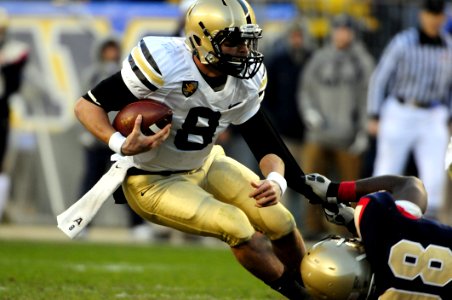Man In Black Jersey Holding Jersey Number 8 With Ball