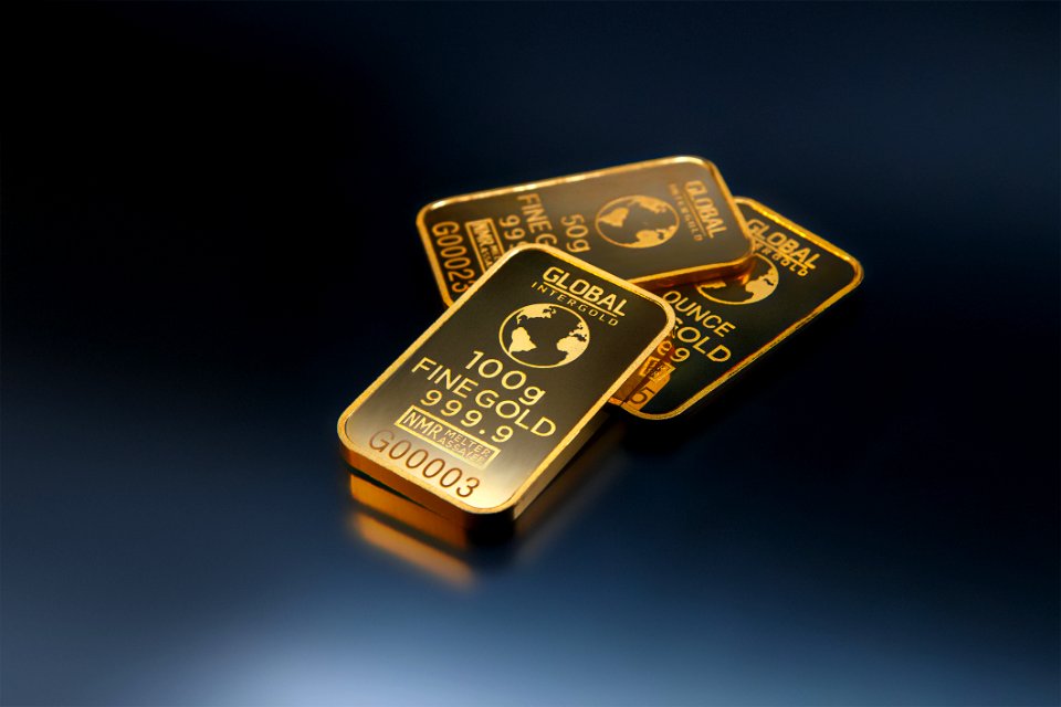 Three Gold Bars Against Dark Background