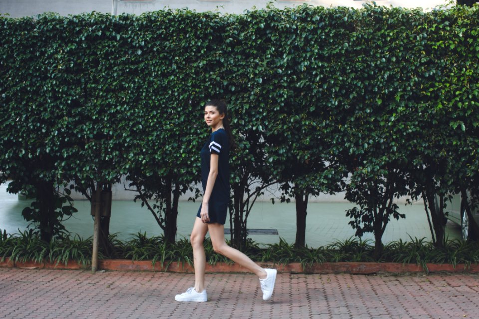 Woman Standing By Tree In The Street