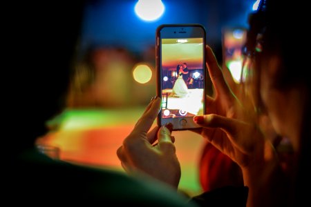 Close-up Of Woman Using Mobile Phone At Night photo