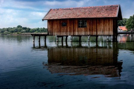 Boathouse Reflecting In Water photo