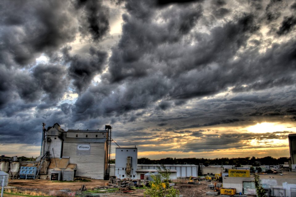 Farm Buildings Against Stormy Skies