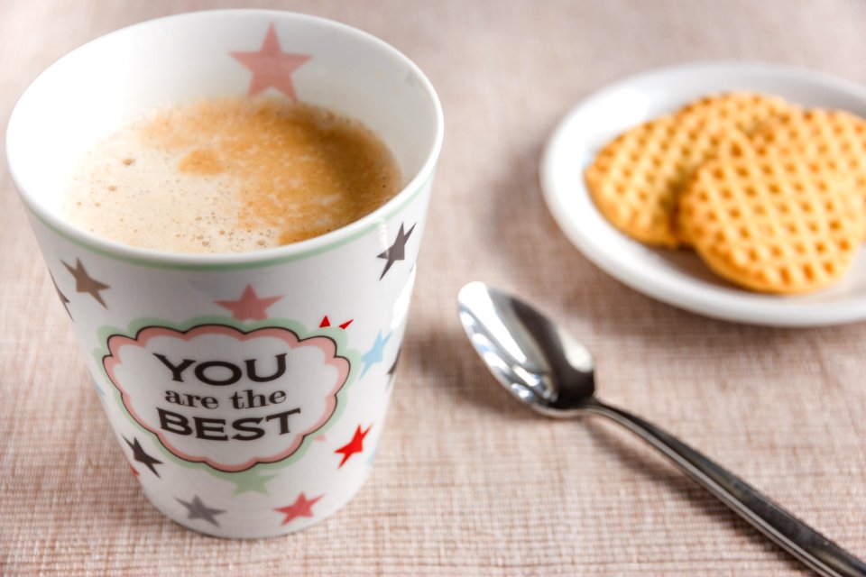 Cup Of Coffee On Table With Biscuits