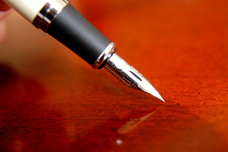 Ink Calligraphy Pen By Wooden Table
